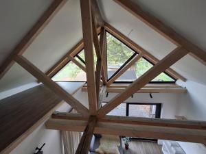 a room with a roof with a window at Merino vendégház in Tiszabecs