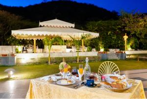 a table with food and drinks and a gazebo at Rajasthali Resort & Spa in Jaipur