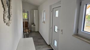 a room with a hallway with a door and a window at Ferienhaus Meli in Pürgen