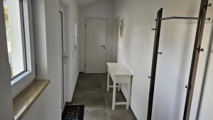 a hallway with a white table and a window at Ferienhaus Meli in Pürgen