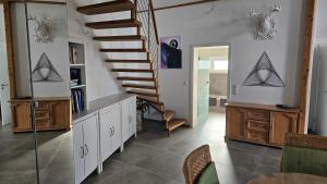 a living room with a spiral staircase in a house at Ferienhaus Meli in Pürgen