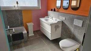 a bathroom with a sink and a toilet at Ferienhaus Meli in Pürgen +12 photos