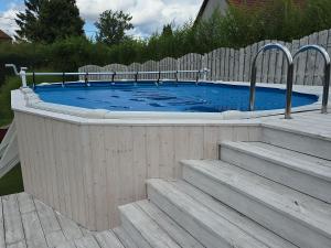 a large plunge pool with stairs in a backyard at Agroturystyka Nad Stawem in Sulęcin