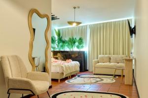 a living room with a bed and a mirror at Davila Peixinho 204 in Aveiro