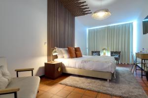a bedroom with a bed and a living room at Davila Peixinho 204 in Aveiro