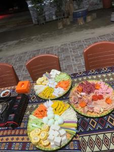 a table with three plates of food on it at Đoàn Kết Homestay in Dồng Văn