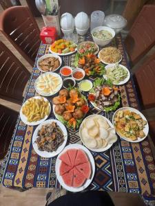 a table with many plates of food on it at Đoàn Kết Homestay in Dồng Văn +4 photos