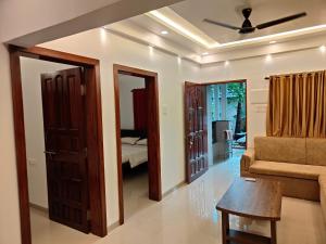 a living room with a couch and a ceiling fan at Little Nest in Mandrem