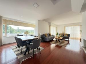 a large living room with a table and chairs at Secret Spot Apartment - Quinta da Barca in Esposende