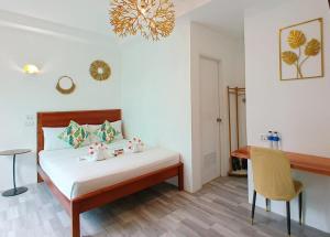 a bedroom with a bed and a table and a chandelier at CiNta Hotel in Boracay