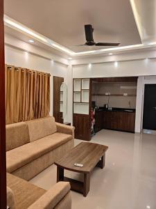 a living room with a couch and a coffee table at Little Nest in Mandrem