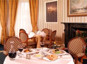 a dining room with a table with food on it at Overwater Hall in Bassenthwaite