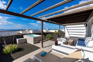 a patio with a view of the ocean at Dream Bocayna Village in Playa Blanca