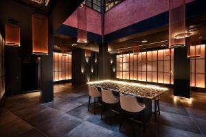 a table in a room with chairs and lights at Gran Tacande Wellness & Relax Costa Adeje in Adeje