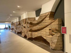 a stone wall in a building with a sign on it at Hotel Cristina by Tigotan Las Palmas - Adults Only in Las Palmas de Gran Canaria