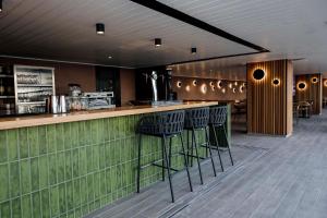 a bar in a restaurant with stools at Hotel Cristina by Tigotan Las Palmas - Adults Only in Las Palmas de Gran Canaria