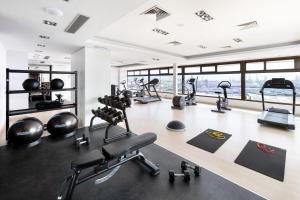a gym with a lot of treadmills and machines at Hotel Cristina by Tigotan Las Palmas - Adults Only in Las Palmas de Gran Canaria +35 photos
