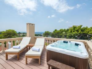 a hot tub on the roof of a balcony at Tacande Portals in Portals Nous