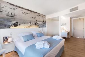 a bedroom with a large bed and a painting on the wall at Tacande Portals in Portals Nous