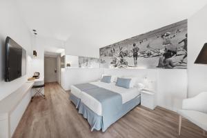 a white bedroom with a bed and a tv at Tacande Portals in Portals Nous +48 photos