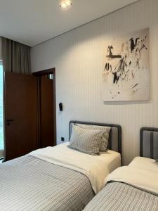 a bedroom with two beds and a picture on the wall at Mosh Mosh Boutique Hotel in Almaty +93 photos