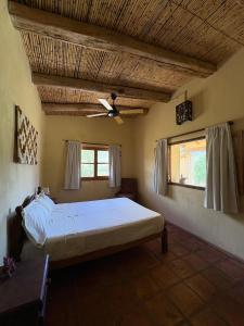 a bedroom with a large bed in a room at Hospedaje Finca la Encantada in Seclantás