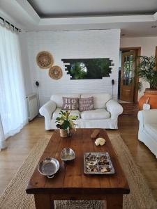 a living room with a white couch and a coffee table at Óbidos Lagoon Refuge in Foz do Arelho
