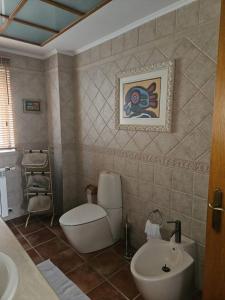a bathroom with a toilet and a sink at Óbidos Lagoon Refuge in Foz do Arelho