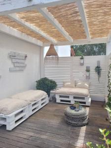 a patio with two beds on a wooden deck at Óbidos Lagoon Refuge in Foz do Arelho