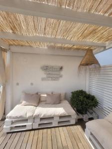 a bedroom with a bed on a wooden floor at Óbidos Lagoon Refuge in Foz do Arelho