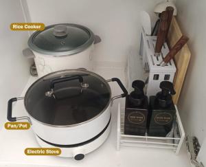 a stove with a pot and some bottles on a counter at CiNta Hotel in Boracay +26 photos