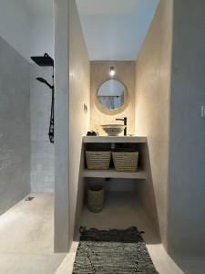a bathroom with a sink and a mirror at Dar Raphael in Essaouira +28 photos