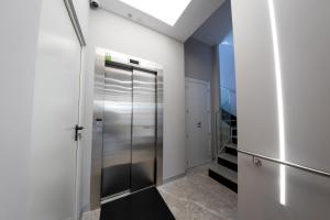 a walk in closet with a stainless steel elevator at Apartamentos Palacio de Yolanda tres cruces in Zamora +61 photos
