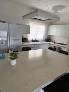 a kitchen with a large white island in a kitchen at דירה 9 in Eilat +6 photos