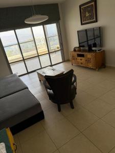 a living room with a couch and a table at דירה 9 in Eilat