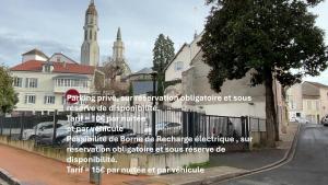 a sign on the side of a building next to a street at Brit Hotel de Grignan Vichy in Vichy