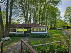 a house in the middle of a field with trees at POD ORŁEM in Wałcz