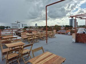 a group of tables and chairs on a roof at Bueno Palace Hotel in Macapá