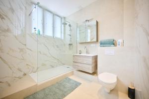 a bathroom with a shower and a toilet and a sink at Louise City 2 in Brussels