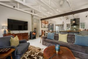 a living room with two couches and a tv at The Oyster Shack by The Oyster Collection in Kenton on Sea