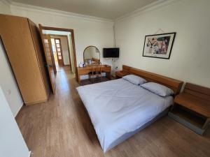 a bedroom with a large white bed and a desk at HighLand Hotel in Aley +18 photos