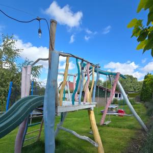 a playground with a slide in a yard at Agroturystyka Nad Stawem in Sulęcin