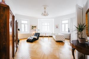 a living room with a couch and a chair at Golf Apartment Villa Elisabeth in Mariánské Lázně