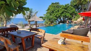 a pool with a table and chairs and a table and a table at Coco Tent Seaview 360 in Ko Lanta