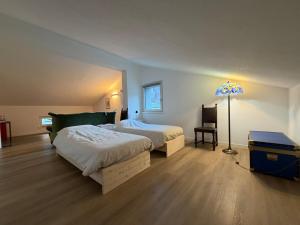 a bedroom with a large bed and a lamp at Beato Mario Apartments in Tirano