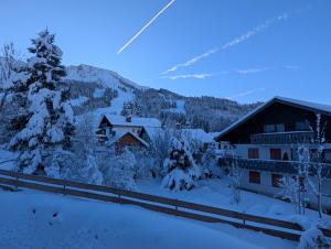 a ski lodge with snow covered trees and buildings at Spatz am Joch in Oberjoch