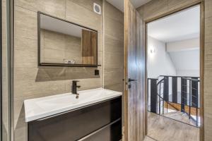 a bathroom with a sink and a mirror at Duplex design avec balcon I Hyper centre Thonon in Thonon-les-Bains +20 photos