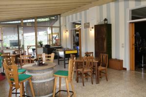 a room with a table and chairs and a barrel at Vesta in Gargnano +41 photos