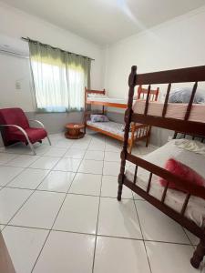 a room with bunk beds and a white tiled floor at HOSTEL SERUSSI in Balneário Camboriú +16 photos