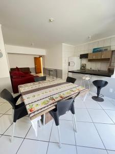 a table with a quilt on it in a kitchen at HOSTEL SERUSSI in Balneário Camboriú